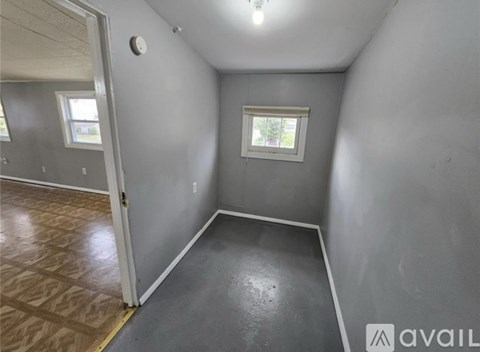 A room with grey walls and a window.