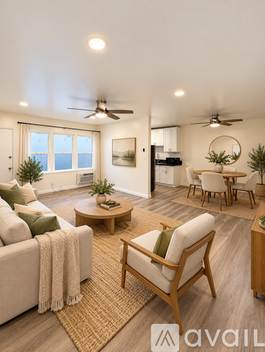 A living room with a couch, chairs, and a dining table.