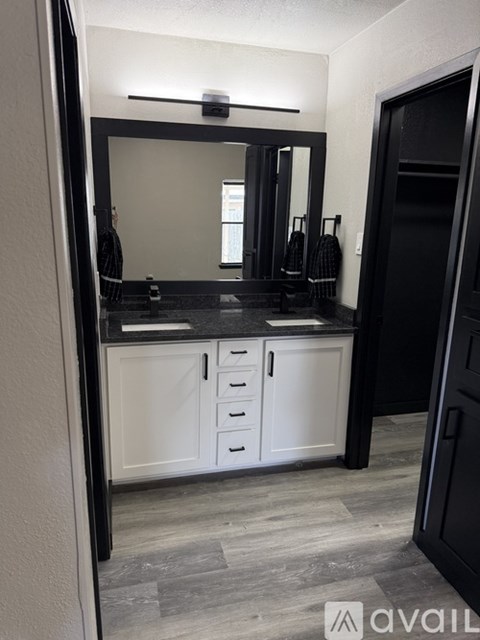A bathroom with a vanity and a mirror.