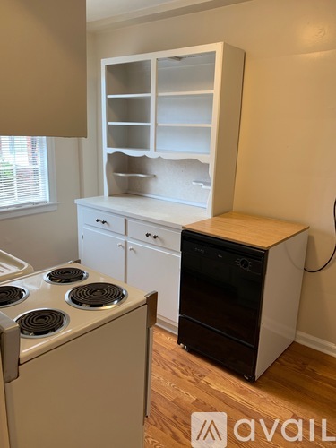 A kitchen with a stove and a cabinet.