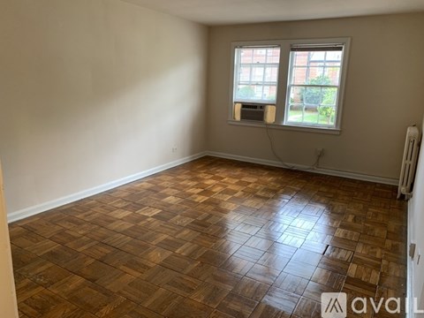 A room with a wooden floor and a window.