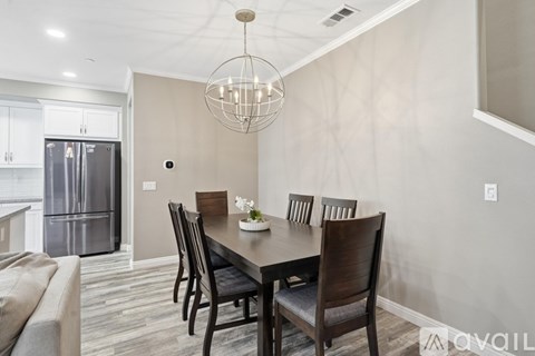 A modern dining room with a table set for four.