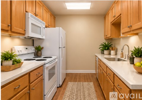 A kitchen with wooden cabinets and white appliances.
