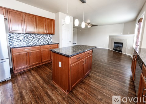 A kitchen with wooden cabinets and a black granite countertop.