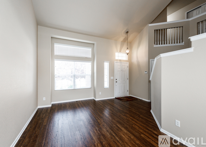 A room with wooden floors and white walls.