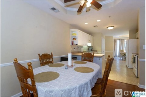 A dining room with a round table and chairs.