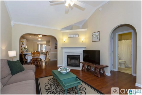 A living room with a fireplace and a television.
