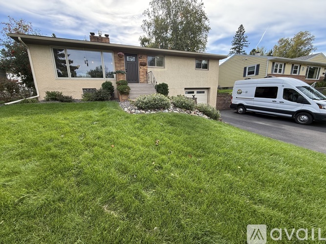 A house with a white van parked in front.