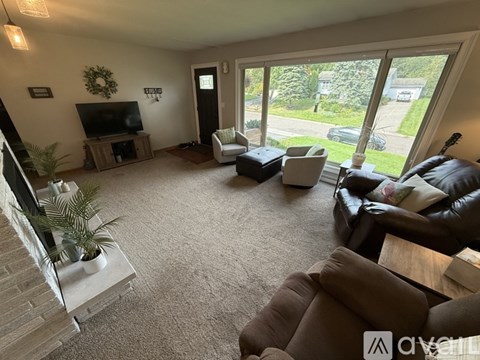A living room with a brown couch and a television.