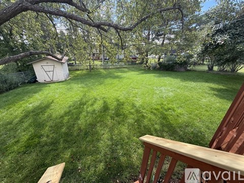 A backyard with a wooden deck and a shed.