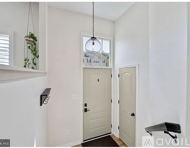 A white door is in the middle of a hallway.