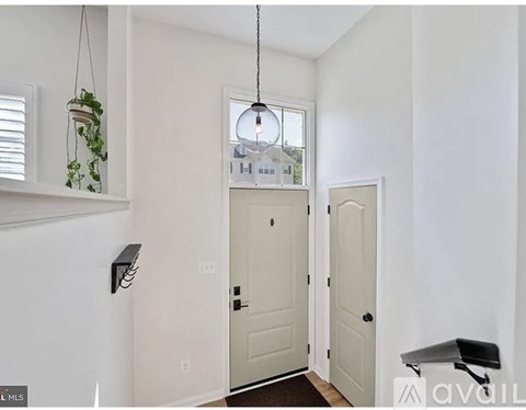 A white door is in the middle of a hallway.