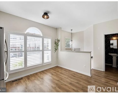 A spacious room with a window and a bar area.