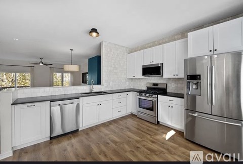 A kitchen with white cabinets and stainless steel appliances.