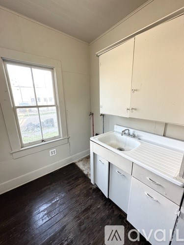 A bathroom with a window and a sink.