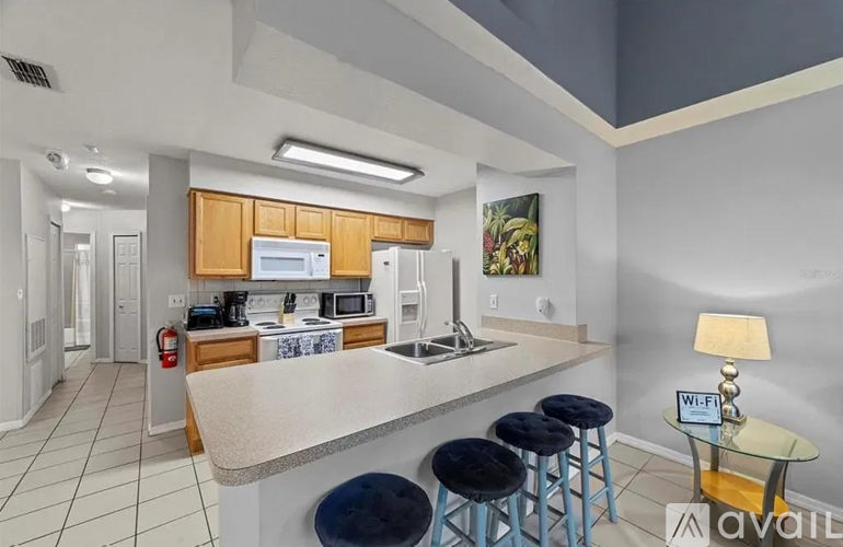 A kitchen with a counter and bar stools.