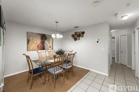 A dining room with a wooden table and chairs.