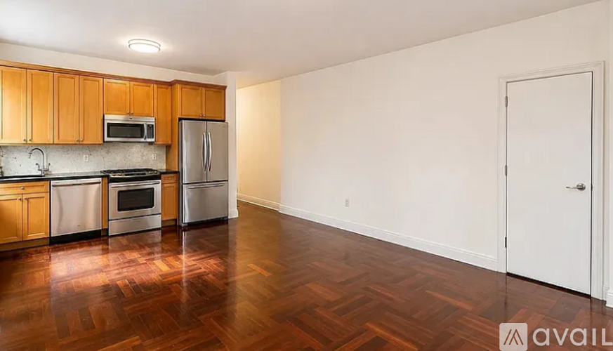A kitchen with wooden cabinets and a white refrigerator.