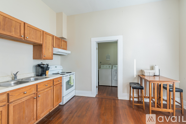 A kitchen with wooden cabinets and a white fridge.