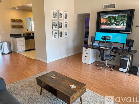 A living room with a television and a coffee table.