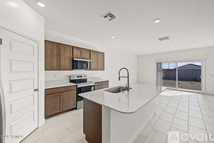 A kitchen with a white countertop and brown cabinets.