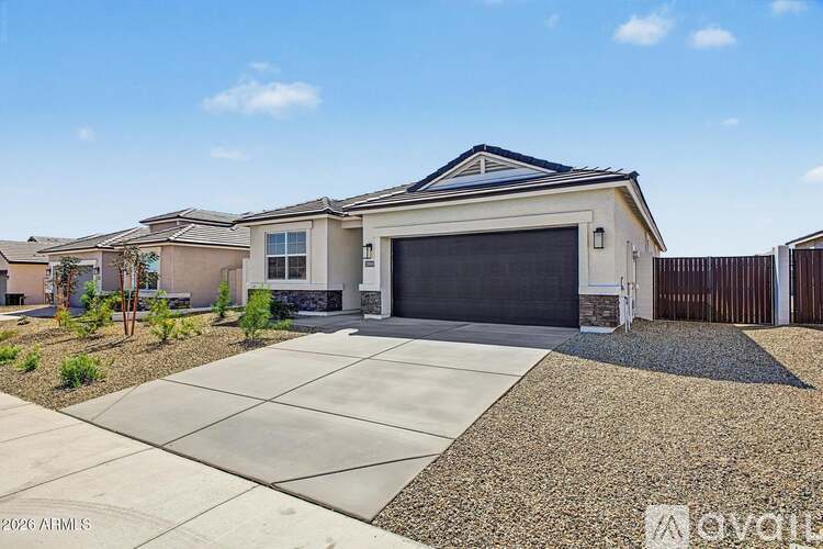 A modern house with a garage door and a driveway.