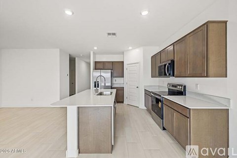 A kitchen with wooden cabinets and a white island.