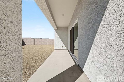 A modern house with a concrete exterior and a glass door.