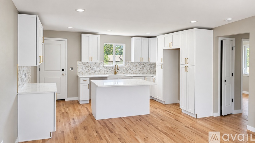 A kitchen with white cabinets and a central island.