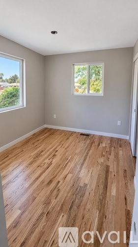 A room with wooden flooring and a window.