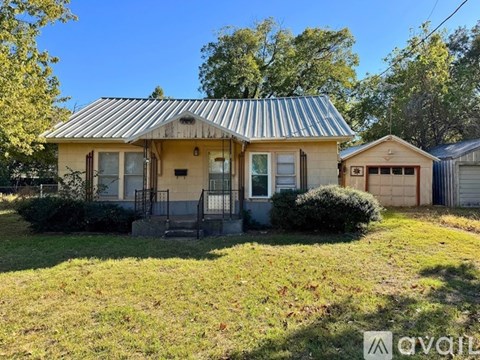 A house with a corrugated metal roof and a front porch.