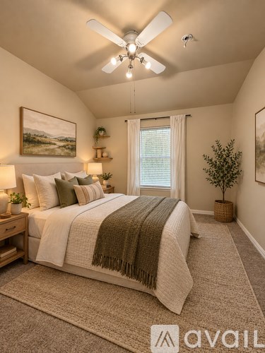 A bedroom with a large bed and a ceiling fan.