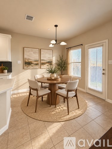 A dining room with a round table and chairs.