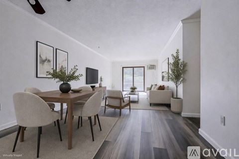 A dining room with a wooden table and chairs.