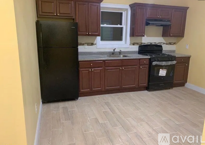 A kitchen with a black fridge, black stove, and black dishwasher.