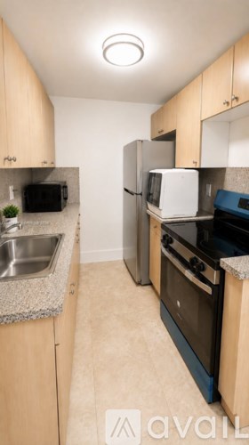 A kitchen with a sink, stove, and refrigerator.