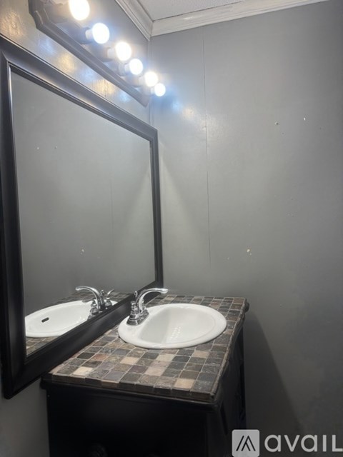 A bathroom with a sink and mirror.