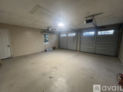 A spacious garage with a door and a window.