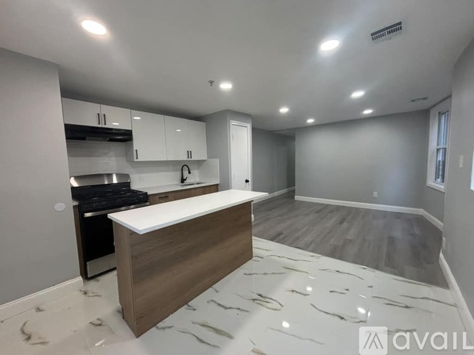 A kitchen with a countertop and cabinets is available for rent.
