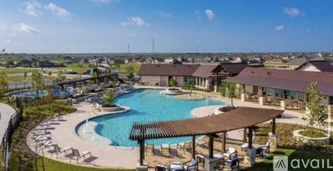 A large outdoor swimming pool surrounded by a pavilion and lounge chairs.