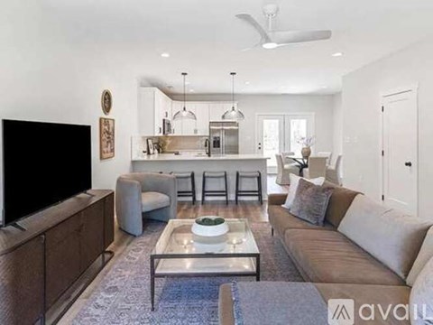 A modern living room with a flat screen TV and a coffee table.