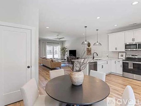 A modern kitchen with a dining table and chairs.