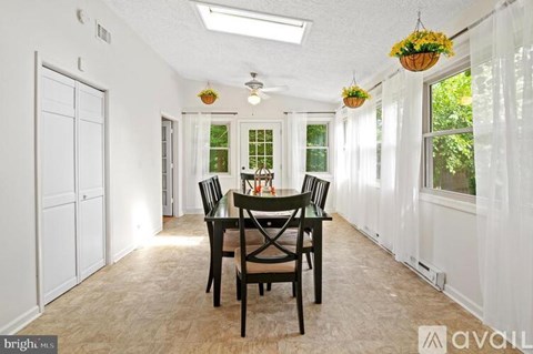 A dining room with a table set for four.