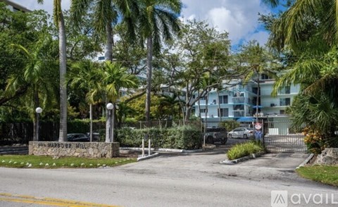 A street view with a sign that says "JOY HARVEY" in front of a building.