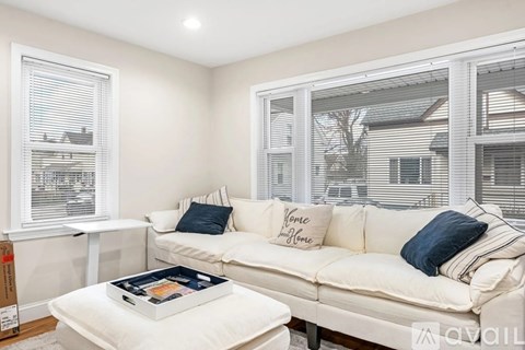 A living room with a white couch and a coffee table.