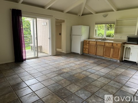 A kitchen with tile flooring and a white refrigerator.