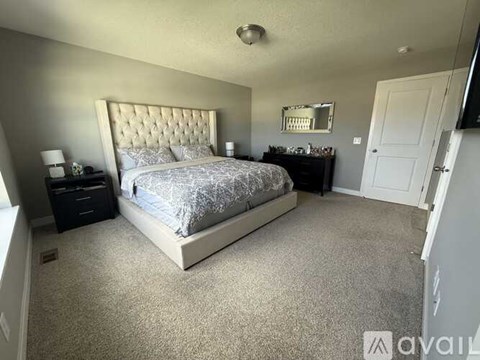 A bedroom with a large bed and a mirror on the wall.