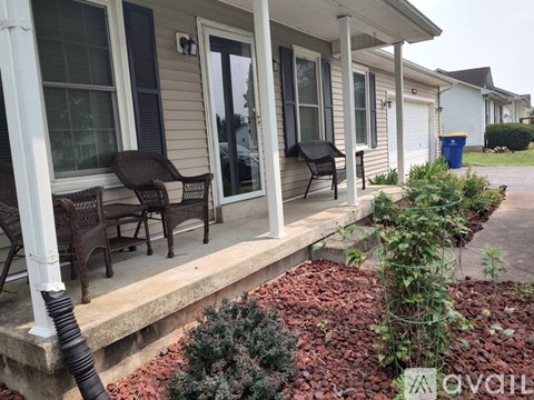 A house with a porch and a small garden.