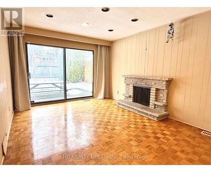 A living room with a fireplace and sliding glass doors.