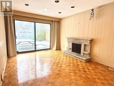A living room with a fireplace and sliding glass doors.